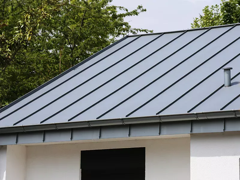 Home with a gray standing seam metal roof